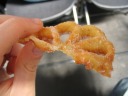 A rosette: a crunchy, inflexible pastry with a thin shell.  Basically,
deep-fried dough, often made in funky shapes and then dipped in sugar. 
Although it looks symmetric, it isn't!  There is no bottom.  That is,
those arches that cover air have nothing underneath them.
