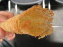 A krumkake: a light, flaky, cone-shaped dessert.  Look how thin it is. 
In texture, it's more like a butter cookie than a waffle or a pancake,
though it's made like the latter.  Apparently the recipe was
Scandinavian but, two centuries ago, immigrants in the Upper Midwest
invented the elaboration of rolling it into a cone, thereby making it
easier to fill with cream and carry.
