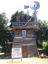An old water tower and weather vane.
