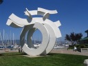 In an Alameda marina, a neat statue of a person swimming through waves.

