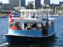 A boat run by the False Creek Ferry company.  I didn't take this one;  I
happened to take the boat of its competitor, shown in the next picture.

