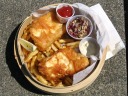 Halibut fish and chips, with coleslaw and condiments.

