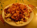 Classic poutine: french fries, gravy, and cheese curds.  Photographed
without a flash.
