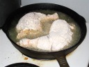 Frying chicken, first side.
