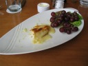 The remains of baked brie.  And grapes.  An unusual dish: each was 
good separately but not in combination.  Also, oddly, the baked 
brie didn't come with any bread.  We'd expected some sort of crusty 
bread appropriate for spreading it on.  Instead we made do with the (soft) breads from our bread basket.
