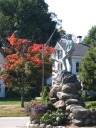 The Minuteman statue in the center of Lexington.  Notice the pretty fall
colors. Summer hadn't yet truly fallen (hehe); hence, we saw few
trees as vibrant as this one.
