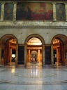 A stately lobby opens onto another ornate lobby.
