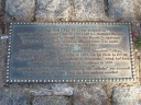 Statue of John Harvard plaque.
