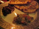 My plate with good navratan korma (peas carrots, cauliflower, green
beans), roti, and missi roti (buttered roti, a la buttered toast).  In
the upper-left is more rogan josh.
