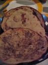 Roti, including ajwain roti.  Ajwain roti, which is hard to find,
is the one dotted with that appear to be fennel seeds (but
are not fennel seeds).  I liked it.  Also, it was certainly more
crispy/toasted than regular roti.

