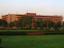 A building near the Rajpath glowed in the sun's setting light, contrasting vividly
with the green from the trees.

