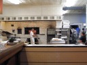 The pizza oven.

While in line, we were told by someone who's been coming here for two 
decades that the charring of the crust depends in part on how often they 
vacuum out the oven.  It happens multiple times each day.  He also 
advised us not to order half-and-halfs, because it's not possible to get 
each half simultaneously cooked to the proper doneness of toppings.
