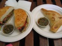 At left, a pork (lomito) sandwich which I watched a woman make by hand.  
The pork was fatty, tendony, and not good quality.  Whereas many 
sandwiches get richness from mayonnaise, this one got it from a thick 
layer of guacamole.  What a neat idea!  The sandwich also contained salted 
tomato slices. 
At right, an empanada containing ground meat, onions, dark olives, and a 
hard-boiled egg.  Although I didn't like it at first, it definitely grew 
on me.  It was better than the sandwich.
