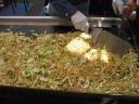 Yakisoba: stir-fried noodles, cabbage, and pork.  I ate some at a previous 
trip to this festival.  
Check out the two large metal spatulas.
