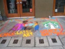 Starbucks (the green logo at right).  Because of all the extra
pictures here, I was tempted to put this in the general sidewalk art
category.
