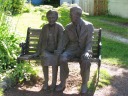 A cute statue of an old couple.
