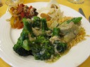 Clockwise from upper-left: red pepper and octopus salad, shrimp chips
with peanut sauce, Thai green curry with chicken thighs, and broccoli
with crab meat.
