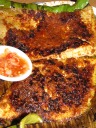 Barbecued stingray (skate), served on a banana leaf.  Skate appears to be
a white fish rich in oil.  The meat comes off in long threads.  The
accompanying pickles (not pictured) were unnecessary.
