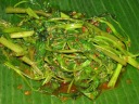 Kangkong.  A spicy, soggy dish tossed with a complex mix of spices,
based principally on fish or oyster sauce and shrimp paste.
