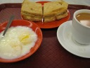 Kaya toast, a (very) soft-boiled egg, and tea with milk.  Kaya is a
coconut-egg jam.  I was initially disappointed with my toast.  It looked
like ordinary toast, though admittedly toasted well, with a slab of
butter.  I wondered if I ordered wrong.  But then I tasted the kaya jam,
so lightly colored as to be practically invisible, and was happy.  I
like this spread on toast.  The butter was unnecessary.  I also
enjoyed my strong tea with milk.  I forgot how good a strongly-brewed,
caffeinated tea can taste.

