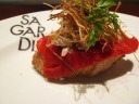 Shredded pork topped with topped with red pepper and good fried sprouts.

