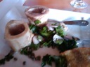 Bone marrow, to be eaten with a spoon on bread, accompanied by a salad. 
Again, sorry about the fuzzy picture.
