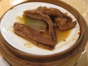 Tripe of some sort.  I think it's a large intestine.  It tasted like 
skin.  Served atop a steamer to remain warm.
