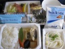 Lunch on the plane.  At top, a weird potato salad, icky mystery meat, okay
lox, and some mushrooms that weren't my thing.  At bottom-left, okay fish,
over-steamed vegetables, and rice (good with the provided seaweed).  At
bottom-right, noodles that were okay once I added the provided sauce.
