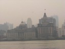 In contrast, this panoramic movie shows the (shorter, older) buildings 
on the Shanghai proper (Puxi) side of the river.  About twenty seconds 
in, the movie begins showing some of the famous colonial buildings on 
The Bund.  At twenty-five seconds: gotta love the advertising barge.

