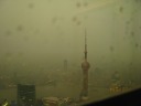 In a thunderstorm, the view from atop the Jinmao tower toward the 
Oriental Pearl TV Tower and across the river to Puxi.

