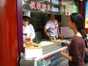 Di Yin watches carefully as the chef gives us some stinky tofu.

