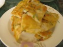 This out-of-focus image (sorry!) is of a fried green onion pancake cut 
into pieces.  It was quite good; I liked the soft inside texture.  I'm not 
sure what kind of dough they used.  (It's not the usual.)
