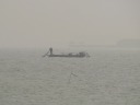 Using my 10x lens, one can see the silhouette of two fisher-people on 
their boat.
