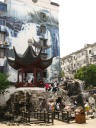 Near the the entrance to Qibao.  I'm amused that behind people 
climbing on / posing on rocks is a billboard of more rocks.

