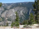 People sitting at the edge of the cliff.
