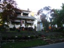 A house with lots of Halloween decorations, including a haunted stagecoach
(at right) and tiny scarecrows by the lanterns next to the steps.  It's a
nice house even aside from the decorations: for instance, the flowers by 
the lawn's retaining wall.  Taken on October 22.
