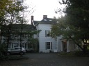 A large house converted into apartments.  We lived in the upper-left of
the building (on the second floor) as viewed from this direction; our four
windows visible in this picture are office/living room, kitchen, kitchen, 
bathroom.

Taken on October 22.


