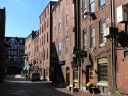The pedestrianized Wharf Street and its many restaurants.  (The
restaurants are not obvious but notice all the signs.)  Brick
buildings such as these are common in Portland.

