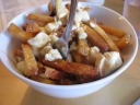 Duckfat's famous poutine: Belgian fries cooked in duck fat with
(pedigreed) curds and duck gravy.  By pedigreed, I mean the menu actually
told us where the curds were made.  The fries were crisp (crisper than Belgian
fry stand in New York), almost like a cross between french fries and
potato chips.  The curds came in large chunks, making them hard to eat in
balance with the fries (though they were easy to cut if one removed them 
and cut them on a plate).  The duck gravy (hard to see in this picture 
because it's at the bottom) was tasty.
