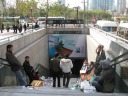 The exit I usually take from the large People's Square/Renmin Square metro
station to get to work.  Depending on the time of day, there are people 
selling stuff on the steps.  (The police make sure these folks aren't 
there during rush hour.)
