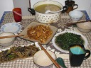 Di Yin's mom moved in with us after her dad flew back to the states.  This 
is the first meal she cooked; she was excited to cook because she'd been 
traveling for the past couple weeks and hadn't had the chance.  Pictured 
are chicken soup, bamboo shoots (peppers, neat fibrous texture), goyi 
berry stalks (tastes wild; also, like a bitter green), and tiny eel with 
ginger and onions.  For dessert we had some rice cakes: black (from black 
sticky rice flour), yellow (sticky rice pounded with corn), and green 
(sticky rice colored with spinach).  All had red bean paste inside.


