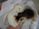 My bbq pork bun (char siu bau / bao).  Not as good (nor as sweet) as those 
in the bay area.  I ordered it because this filling is a Cantonese thing: 
though steamed bun stands are everywhere in Shanghai, none sell this type 
of bun.


