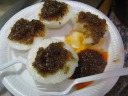 Shui kway (a.k.a. chwee kueh): heavy (physically, i.e., dense), steamed
rice cakes topped with pickled onions and optional chili sauce (sambal).  
I like these, as I did the 
first time I tried
them in Singapore.  Though both are made from steamed rice flour,
they're definitely incomparable to kueh, which I found I generally don't
appreciate.  Maybe it's a savory versus sweet thing.

