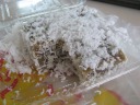 Kueh kosui, a sticky rice cake covered with coconut flakes.
