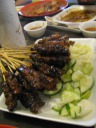 Beef and chicken satays.  Peanut sauce not shown.   Sorry about the 
focus.
