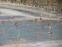 Definitely frozen: you can see kids on something like sleds on the ice, 
and bigger kids on something like a bicycle.

