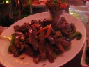 Beef with straw mushrooms and kale.  Chewy beef, but it tastes good.  When 
I returned to this dish later in the evening when it was cool, the 
chewiness was gone but the flavor remained. :)

