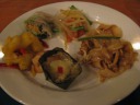 My first plate, clockwise from top:
papaya salad - lunch's 
was better.
pad thai - it lacked peanuts, which I consider important to the 
dish.
amok fish - fish, mashed like a paste into a casserole, steamed 
in coconut milk in banana leaf.  The best dish on the plate.
shrimp with pineapple.
spring roll.

