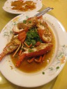 Sauteed lobster in a sauce and covered in garlic.
