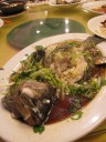 Whole steamed fish, mostly devoured by this point.
